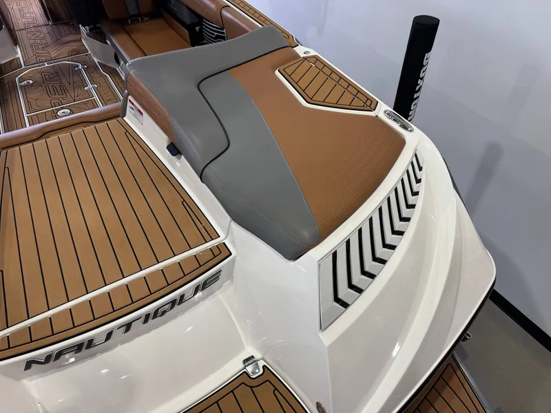 Slide: The Image of 2019 Nautique Super Air Nautique G25 boat interior, brown and gray upholstery. - 11