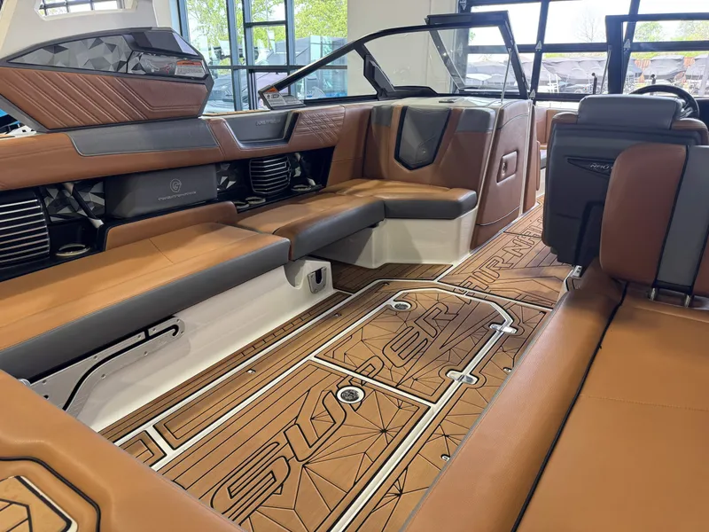 Slide: The Image of Interior of a 2019 Nautique Super Air Nautique G25 boat with brown seating. - 14