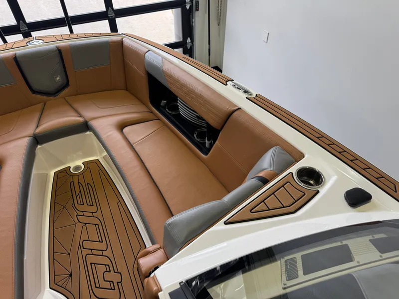 Slide: The Image of Interior of 2019 Nautique Super Air Nautique G25 with brown leather seating. - 18