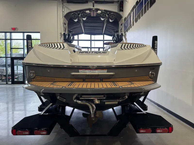 Slide: The Image of Rear view of a 2019 Nautique Super Air Nautique G25 boat in showroom. - 6