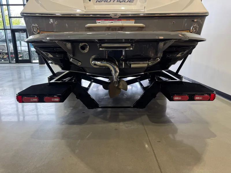 Slide: The Image of Rear view of a 2019 Nautique Super Air Nautique G25 boat in showroom. - 7