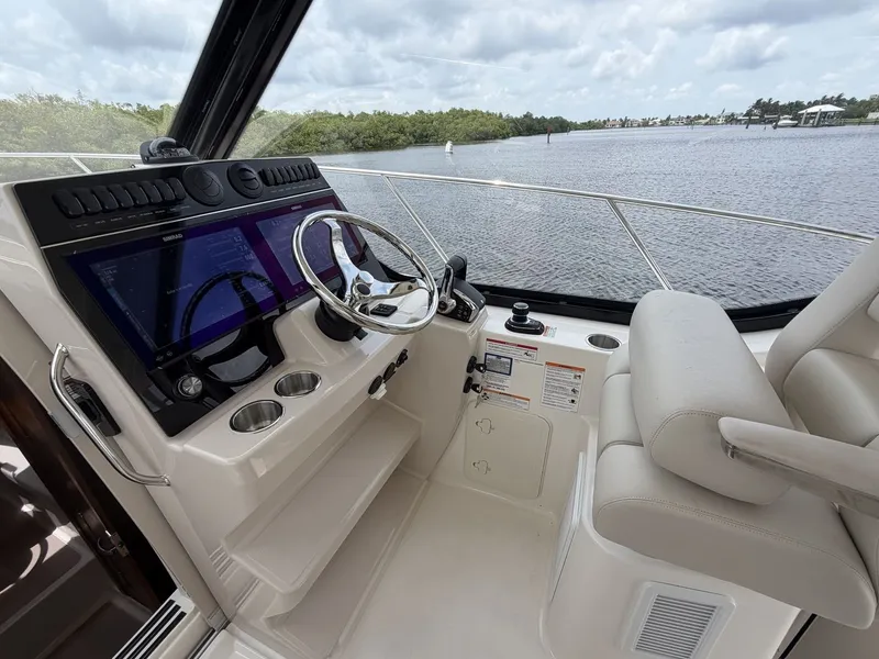 Slide: The Image of The 2027 Boston Whaler 325 Conquest cockpit features a modern helm with dual screens. - 17