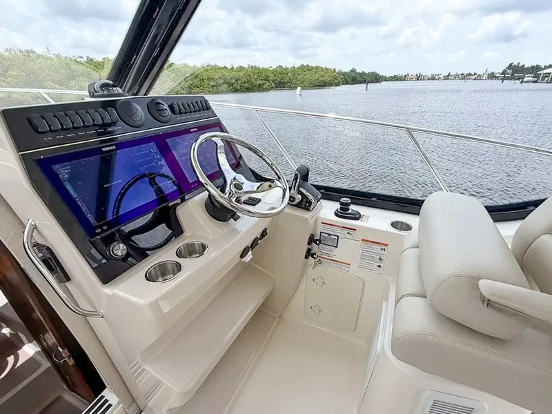 Slide: The Image of The 2027 Boston Whaler 325 Conquest cockpit features a modern helm with dual screens. - 18