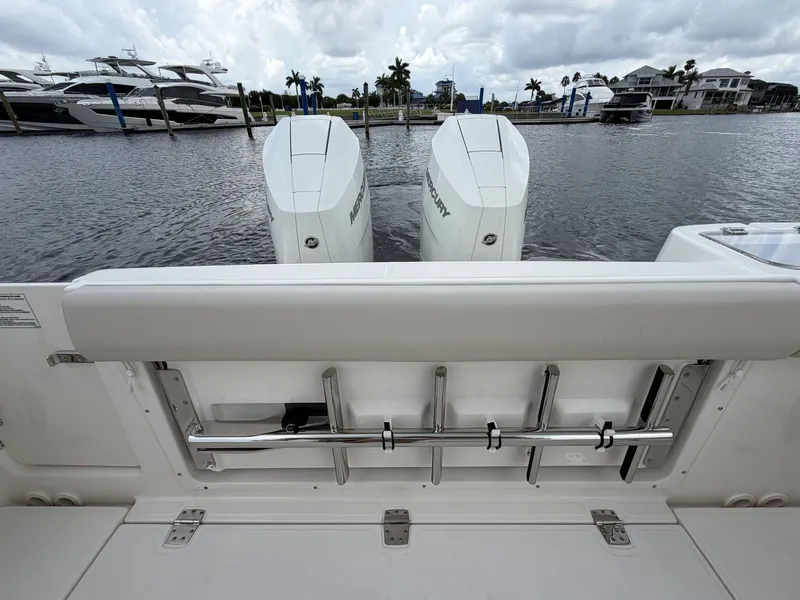 Slide: The Image of Rear view of a Boston Whaler 325 Conquest with twin Mercury outboard engines, docked at a marina. - 7