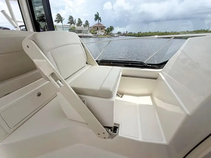 Slide: The Image of The image shows the seating area of a Boston Whaler 325 Conquest boat overlooking the water. - 17