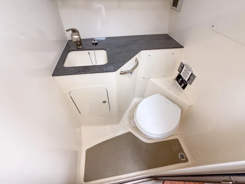 Slide: The Image of The image shows a modern boat bathroom with a sink and toilet. - 28