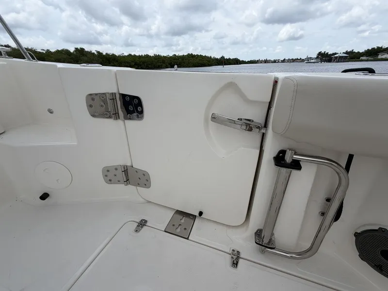 Slide: The Image of The 2027 Boston Whaler 325 Conquest features a sturdy door with stainless steel fittings and a handle. - 10