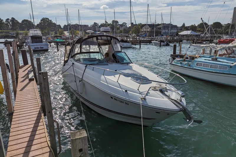 Slide: The Image of 2010 Sea Ray Sundancer 280 docked at a marina, surrounded by other boats. - 1
