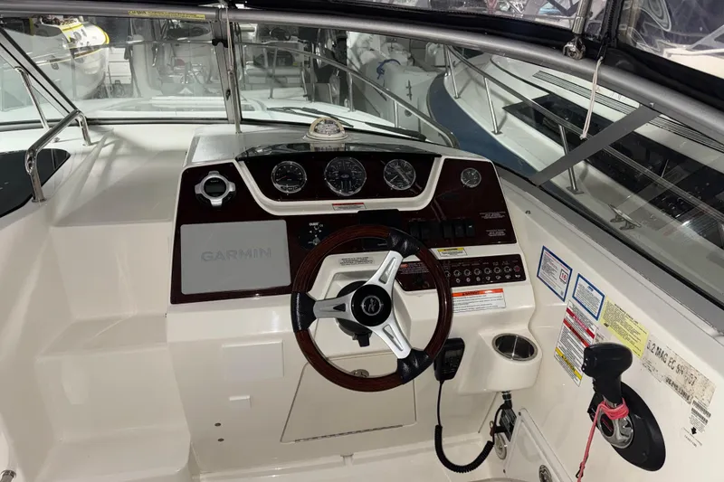 Slide: The Image of Cockpit of 2010 Sea Ray Sundancer 280 with Garmin navigation system and steering wheel. - 10
