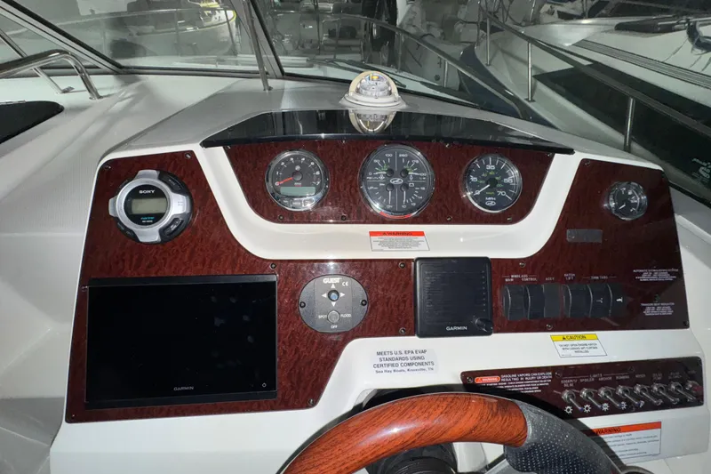 Slide: The Image of Dashboard of a 2010 Sea Ray Sundancer 280 boat with gauges and controls. - 11