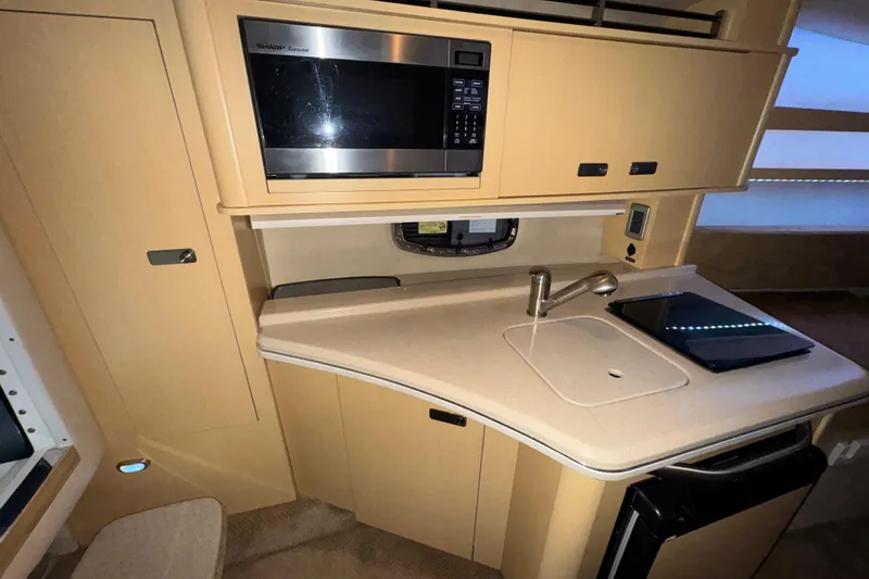 Slide: The Image of 2010 Sea Ray Sundancer 280 galley with microwave, sink, and countertop. - 15