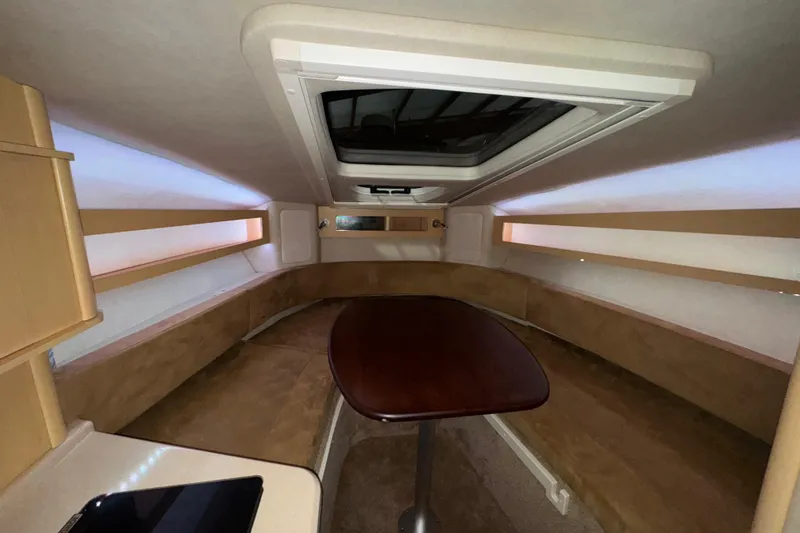 Slide: The Image of Interior cabin of 2010 Sea Ray Sundancer 280 with seating and table. - 17