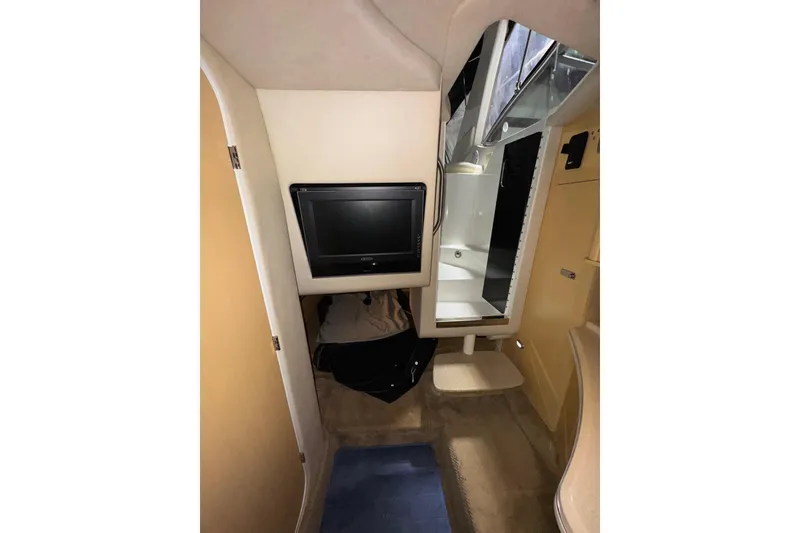 Slide: The Image of Interior of 2010 Sea Ray Sundancer 280 with TV and bathroom view. - 18
