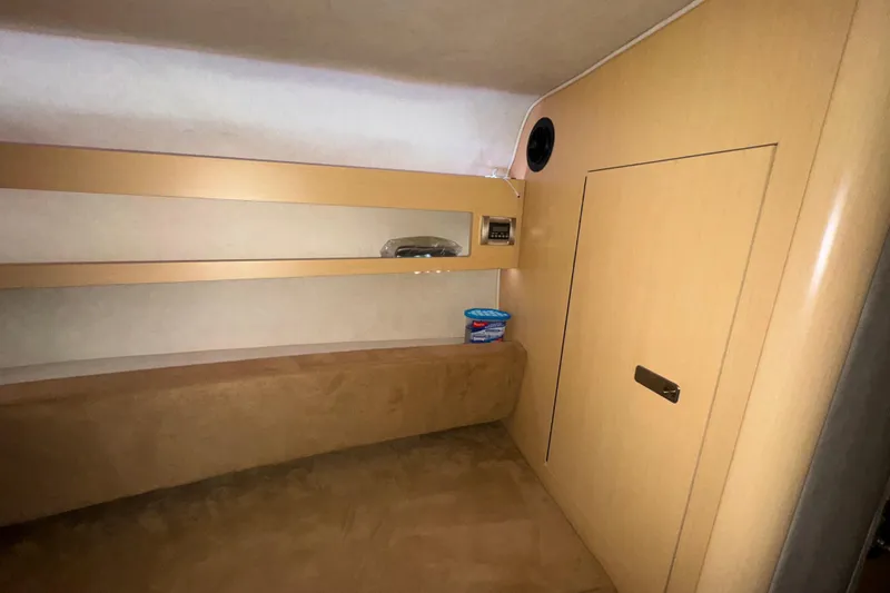 Slide: The Image of Interior cabin of 2010 Sea Ray Sundancer 280 with beige upholstery and wooden paneling. - 19