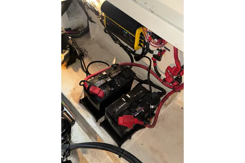Slide: The Image of Battery compartment of a 2010 Sea Ray Sundancer 280 boat with wiring and charger. - 24