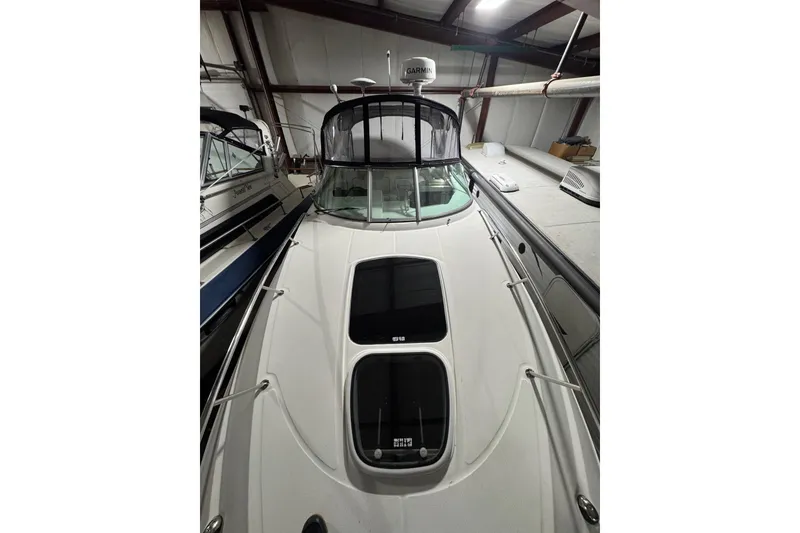 Slide: The Image of 2010 Sea Ray Sundancer 280 yacht in indoor storage, showcasing sleek design and modern features. - 3