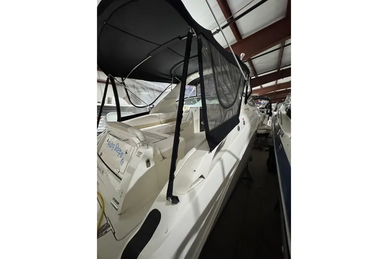 Slide: The Image of 2010 Sea Ray Sundancer 280 boat with black canopy in storage facility. - 5