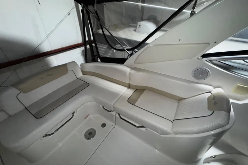 Slide: The Image of 2010 Sea Ray Sundancer 280 interior with white seating and sleek design. - 8