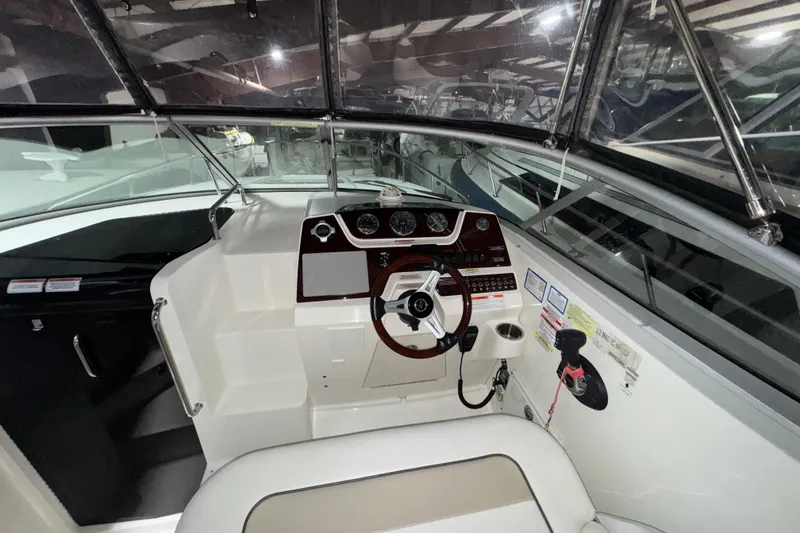 Slide: The Image of 2010 Sea Ray Sundancer 280 cockpit with steering wheel and control panel. - 9