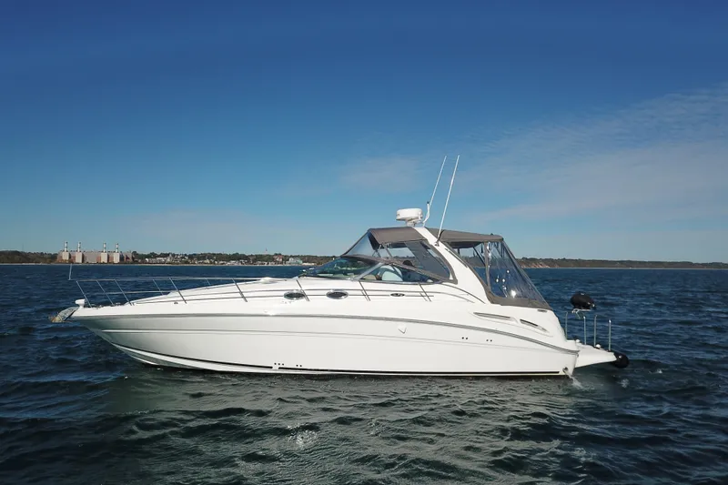 Slide: The Image of 2005 Sea Ray 360 Sundancer yacht on open water under clear blue sky. - 13
