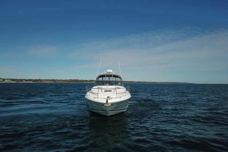 Slide: The Image of 2005 Sea Ray 360 Sundancer yacht cruising on open water under clear blue sky. - 15
