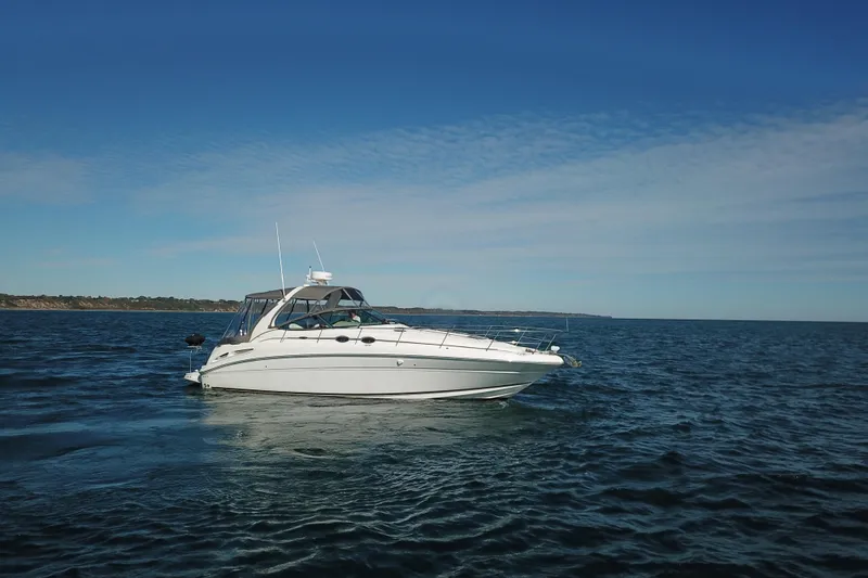Slide: The Image of 2005 Sea Ray 360 Sundancer yacht cruising on open water under clear skies. - 18