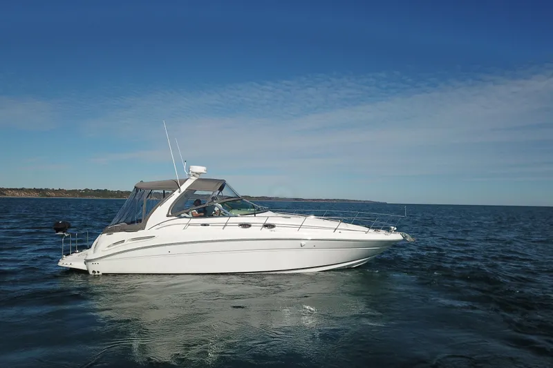 Slide: The Image of 2005 Sea Ray 360 Sundancer yacht cruising on open water under clear skies. - 19