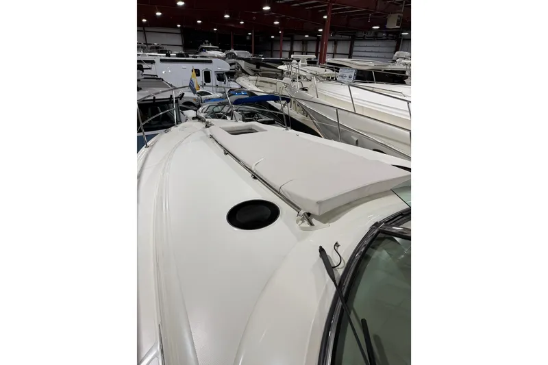 Slide: The Image of 2005 Sea Ray 360 Sundancer yacht in indoor storage, showcasing sleek deck design. - 22