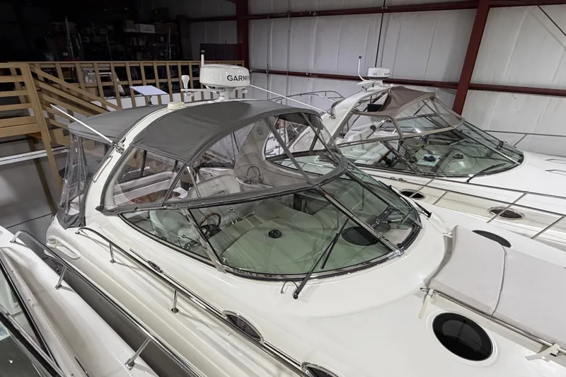 Slide: The Image of 2005 Sea Ray 360 Sundancer yacht in storage, featuring sleek design and covered cockpit. - 25