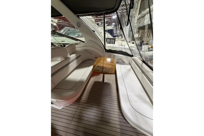 Slide: The Image of 2005 Sea Ray 360 Sundancer interior with white seating and wooden table. - 29