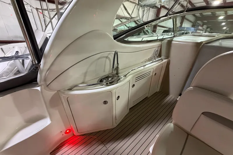 Slide: The Image of 2005 Sea Ray 360 Sundancer interior with sink and seating, showcasing elegant design. - 30