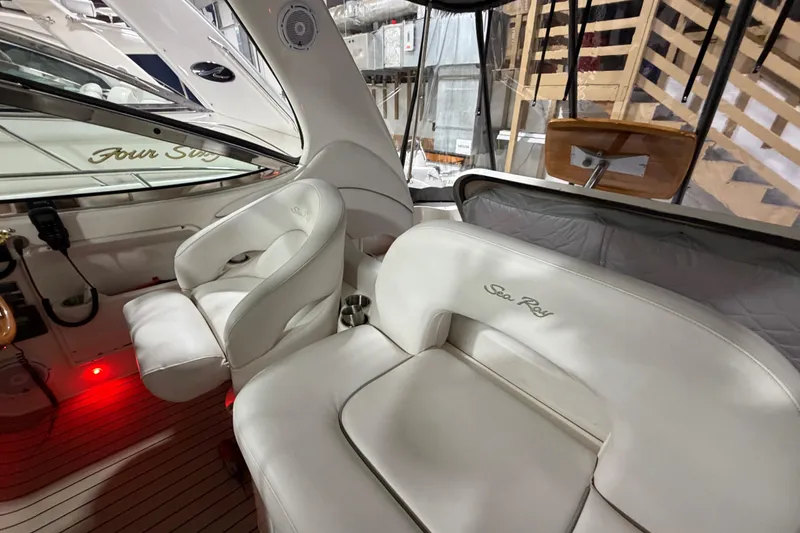 Slide: The Image of Interior of 2005 Sea Ray 360 Sundancer with white leather seating and wood accents. - 33