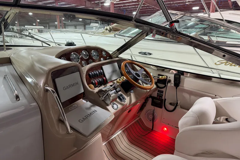 Slide: The Image of 2005 Sea Ray 360 Sundancer helm with Garmin navigation, wood accents, and leather seating. - 34