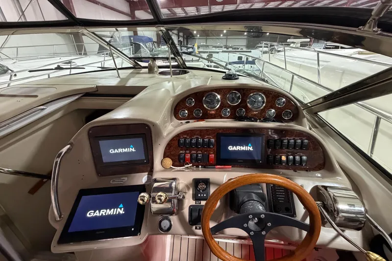 Slide: The Image of Helm of 2005 Sea Ray 360 Sundancer with Garmin navigation displays and wooden steering wheel. - 37