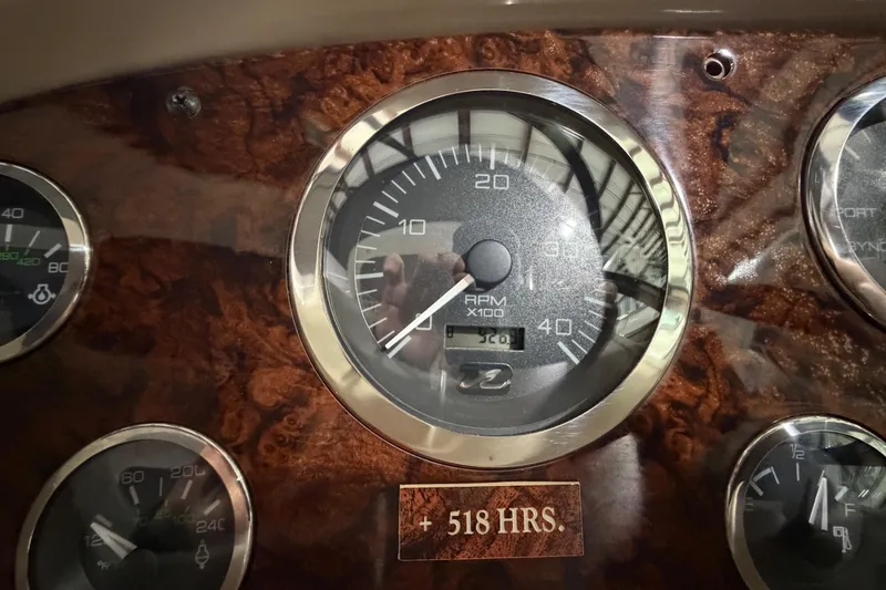 Slide: The Image of Dashboard of 2005 Sea Ray 360 Sundancer showing RPM gauge and 518 hours. - 38