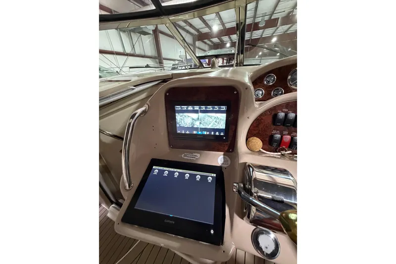Slide: The Image of 2005 Sea Ray 360 Sundancer helm with modern navigation displays and controls. - 40