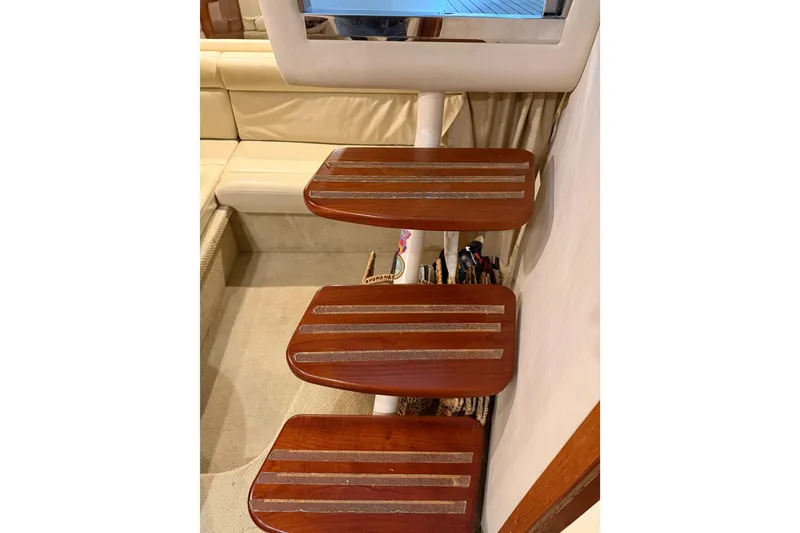 Slide: The Image of Wooden steps inside a 2005 Sea Ray 360 Sundancer yacht, leading to a cozy seating area. - 44