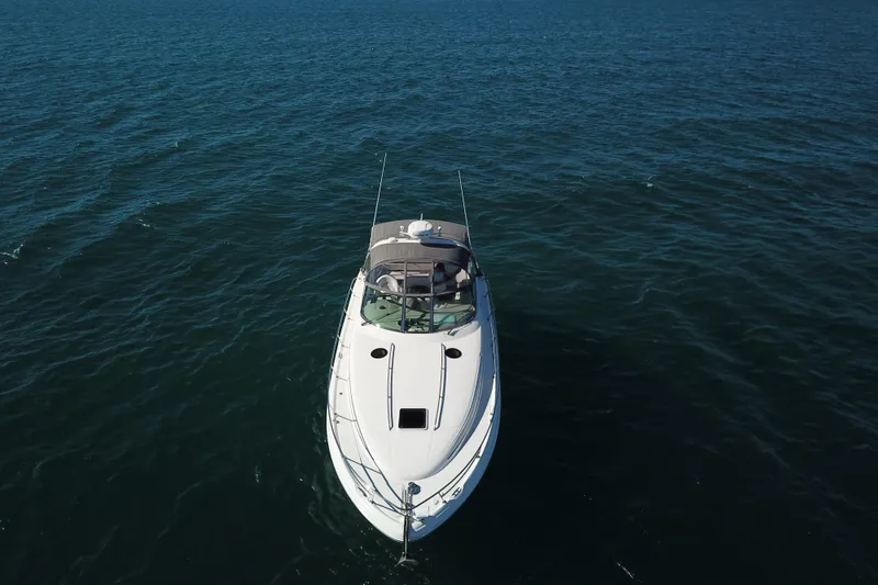 Slide: The Image of 2005 Sea Ray 360 Sundancer cruising on open water, aerial view. - 5