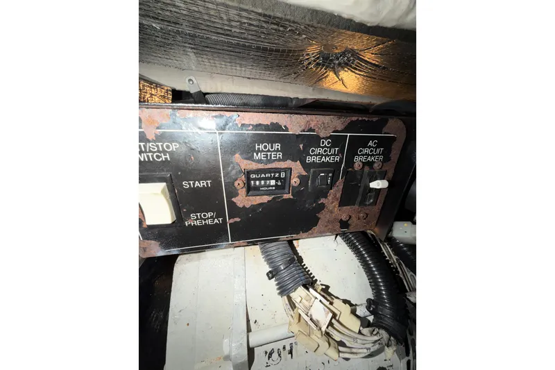 Slide: The Image of Control panel of a 2005 Sea Ray 360 Sundancer with hour meter and circuit breakers. - 58