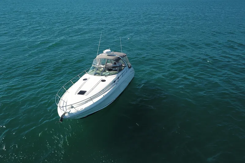 Slide: The Image of 2005 Sea Ray 360 Sundancer yacht cruising on open blue waters. - 6