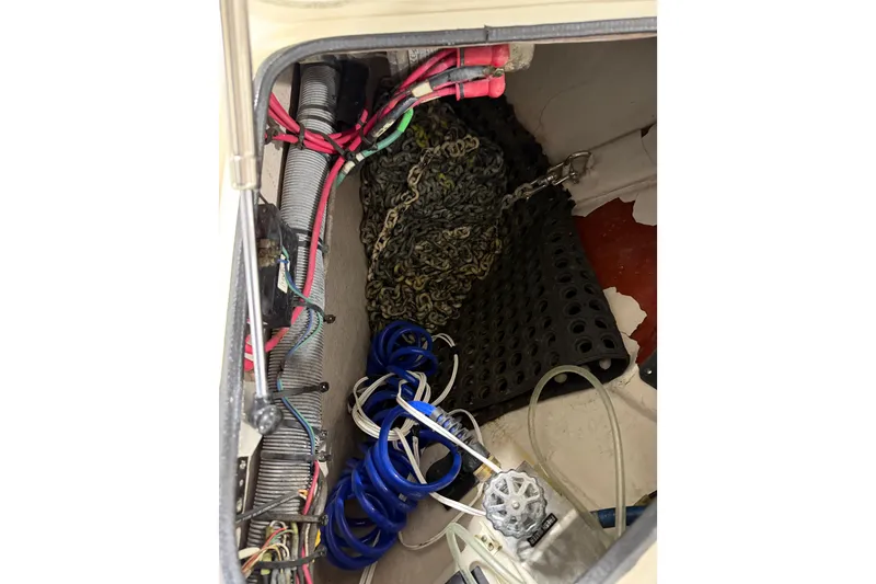 Slide: The Image of Storage compartment of a 2005 Sea Ray 360 Sundancer with cables and chains. - 64