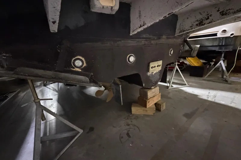 Slide: The Image of 2005 Sea Ray 360 Sundancer boat hull on stands in a workshop. - 65