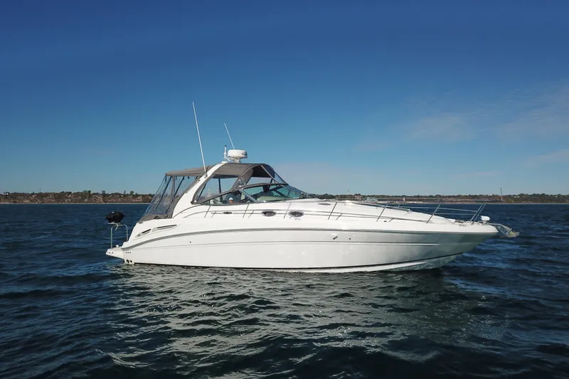 Slide: The Image of 2005 Sea Ray 360 Sundancer yacht on open water under clear blue sky. - 8