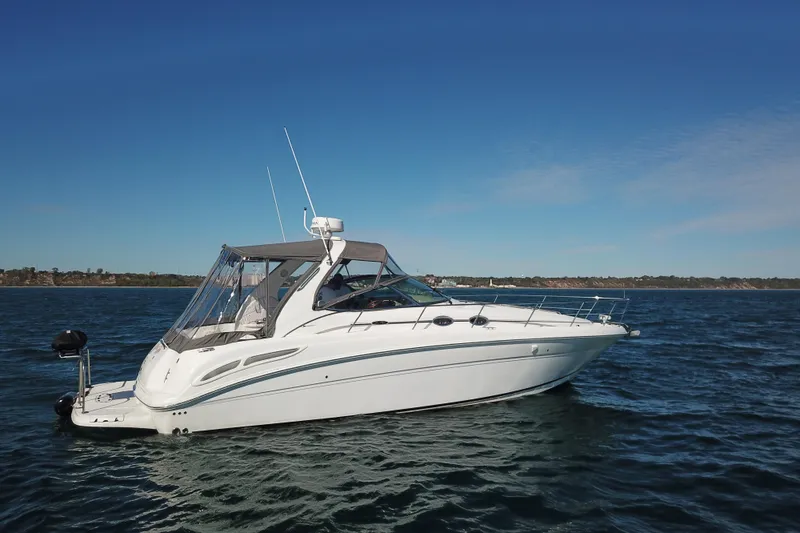 Slide: The Image of 2005 Sea Ray 360 Sundancer yacht cruising on open water under clear blue skies. - 9