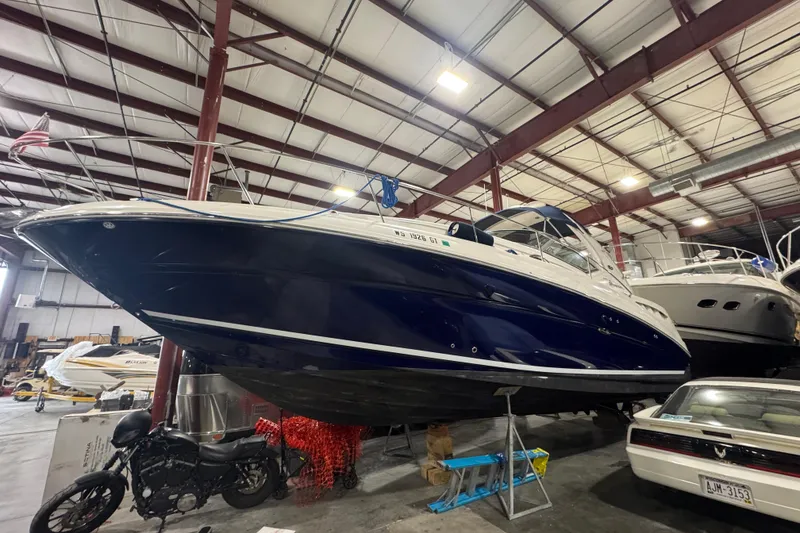 Slide: The Image of 2004 Sea Ray Sundancer 320 boat in indoor storage facility. - 24