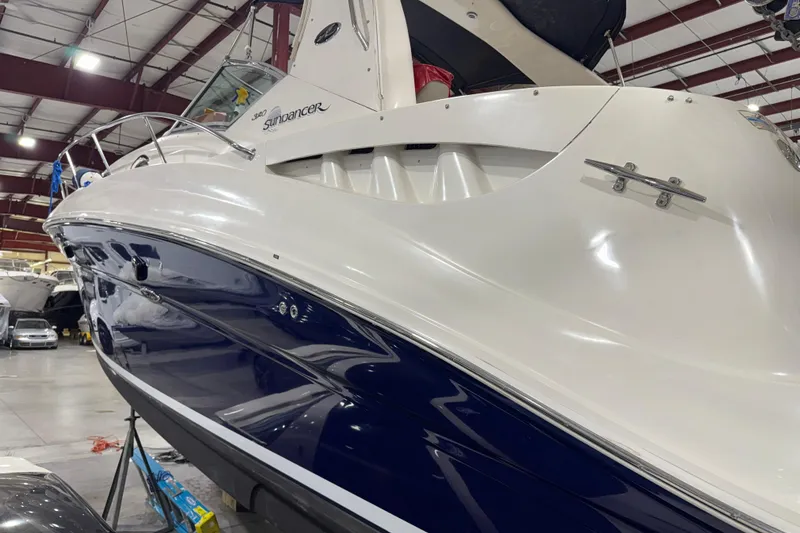 Slide: The Image of 2004 Sea Ray Sundancer 320 yacht in indoor storage, showcasing sleek design and polished finish. - 28