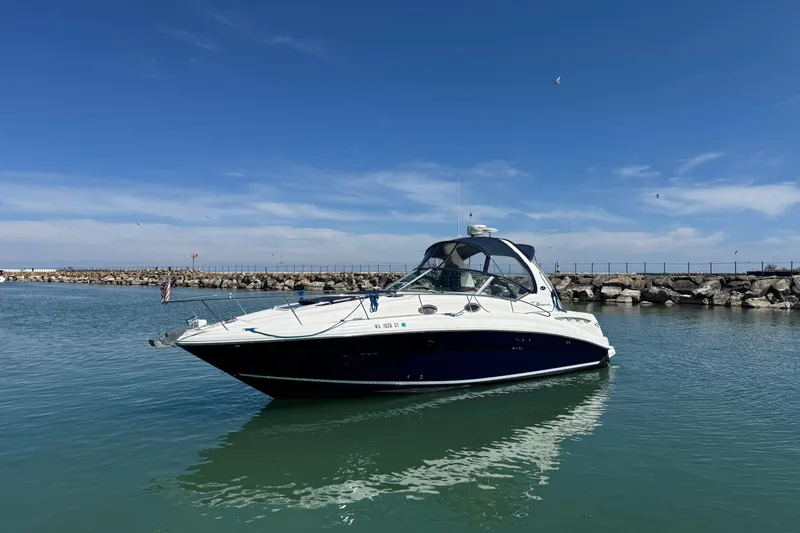 Slide: The Image of 2004 Sea Ray Sundancer 320 yacht on calm water with clear blue sky. - 3