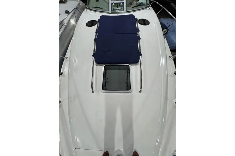 Slide: The Image of 2004 Sea Ray Sundancer 320 boat deck with blue sun pad and hatch. - 32