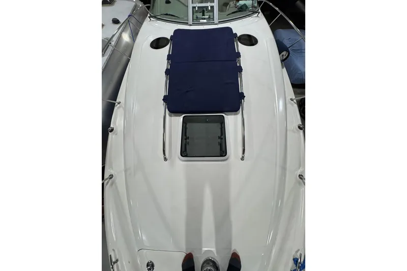 Slide: The Image of 2004 Sea Ray Sundancer 320 boat deck with blue sun pad and hatch. - 33