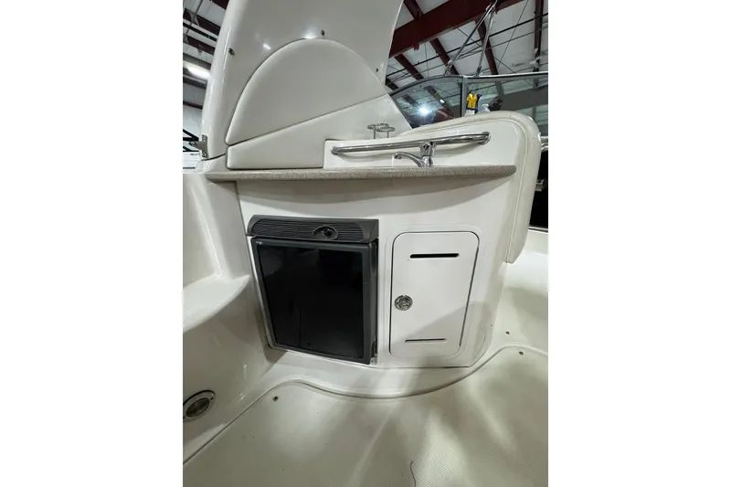 Slide: The Image of 2004 Sea Ray Sundancer 320 boat interior with sink and storage compartments. - 36